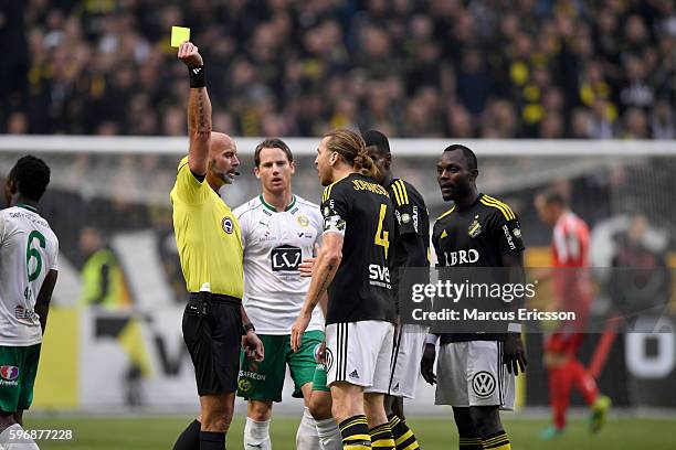 Nils-Eric Johansson of AIK shown a yellow card for bad behavior during the allsvenskan match between AIK and Hammarby IF at Friends arena on August...