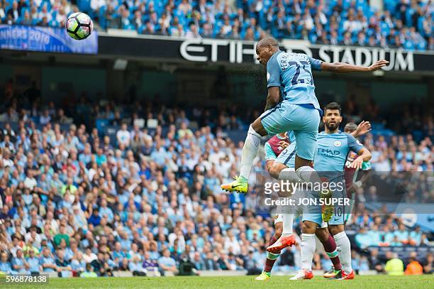 Manchester City's Brazilian midfielder Fernandinho jumps to score their second goal from this header during the English Premier League football match...