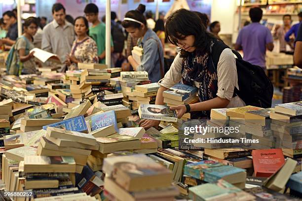 Visitors browse through books at the Delhi Book Fair at Pragati Maidan, on August 28, 2016 in New Delhi, India. The 9-day-long fair is organised by...