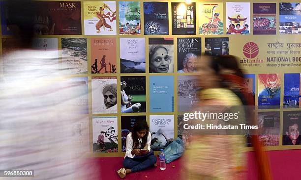 Visitors walk past a display at the Delhi Book Fair at Pragati Maidan, on August 28, 2016 in New Delhi, India. The 9-day-long fair is organised by...