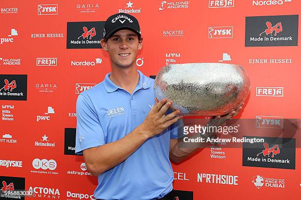 Thomas Pieters of Belgium poses with the trophy following his victory during the final round of Made in Denmark at Himmerland Golf & Spa Resort on...