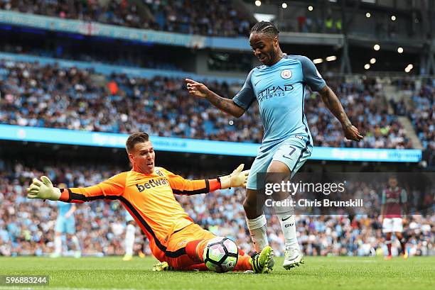 Raheem Sterling of Manchester City rounds goalkeeper Adrian of West Ham United to score his second goal and his team's third during the Premier...