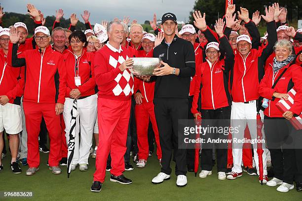 Thomas Pieters of Belgium poses with the trophy, Lars Larsen the owner of Himmerland Golf & Spa Resort and tournament volunteers following his...