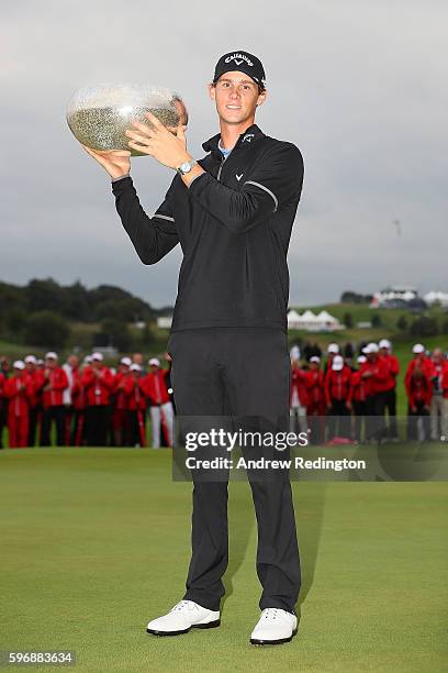 Thomas Pieters of Belgium poses with the trophy following his victory during the final round of Made in Denmark at Himmerland Golf & Spa Resort on...