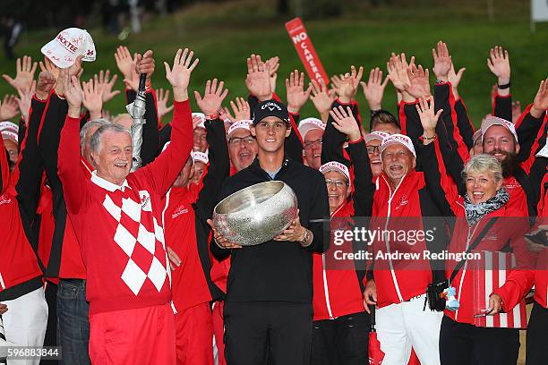 Thomas Pieters of Belgium poses with the trophy, Lars Larsen the owner of Himmerland Golf & Spa Resort and tournament volunteers following his...