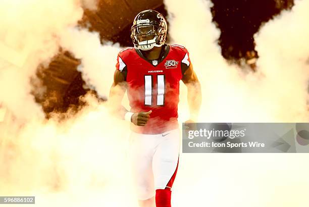 Atlanta Falcons wide receiver Julio Jones emerges from the smoke during the introductions before the start of the NFL game between the Eagles and the...