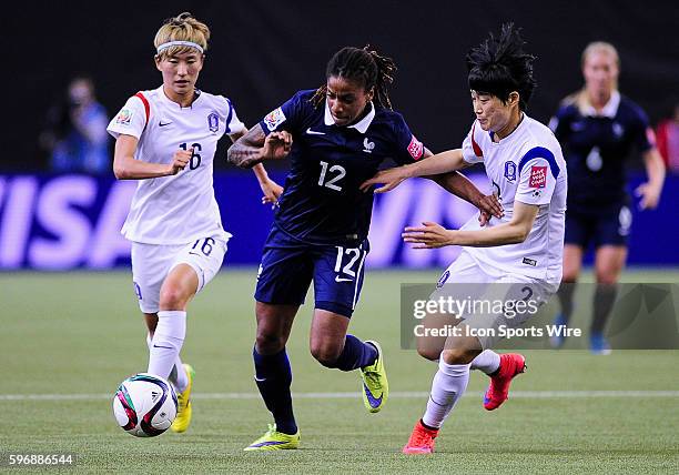 Midfielder Elodie Thomis of France holds off defender Lee Eunmi of Korea Republic during the FIFA 2015 Women's World Cup Round of 16 match between...