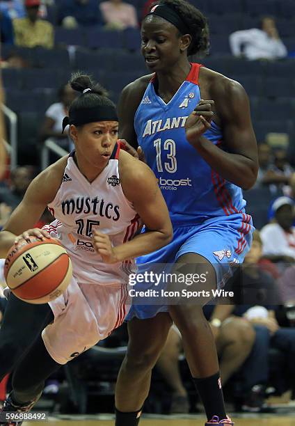 Washington Mystics guard Natasha Cloud dribbles past Atlanta Dream forward Aneika Henry during a WNBA basketball game at Verizon Center, in...
