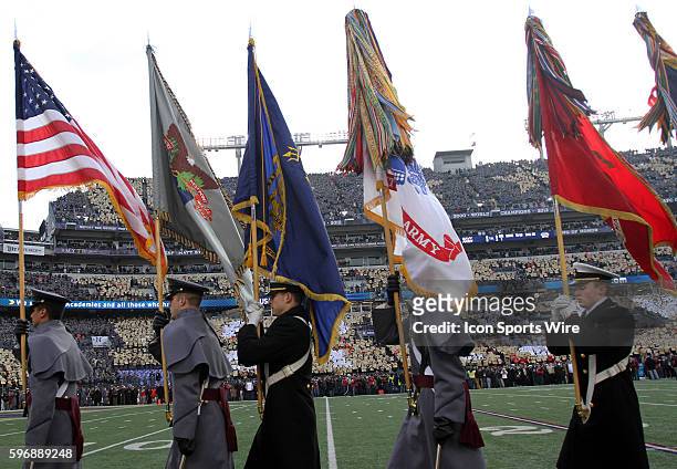 American and other military flags are displayed proudly in front of the fans before a match between Army and Navy at M&T Bank Stadium in Baltimore,...