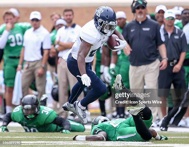 Rice RB Austin Walter jumps over North Texas DB Keshawn McClain during the NCAA football game between Rice versus North Texas played at Apogee...