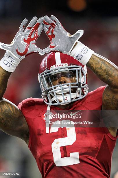 Alabama Crimson Tide running back Derrick Henry throws up the Alabama sign after scoring a touchdown during the game between the Alabama Crimson Tide...