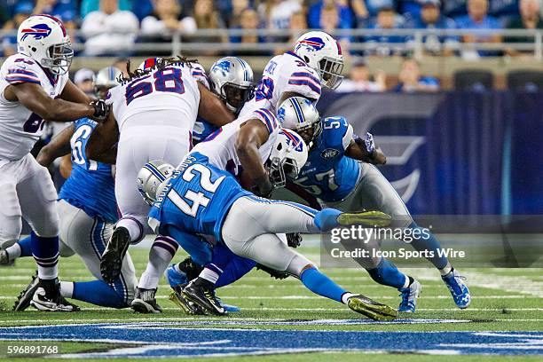 Detroit Lions safety Isa Abdul-Quddus and Detroit Lions linebacker Josh Bynes tackle Buffalo Bills running back Bryce Brown during game action...