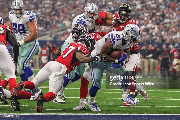 Dallas Cowboys running back Joseph Randle fights through the line of scrimmage to score a touchdown during the game between the Dallas Cowboys and...
