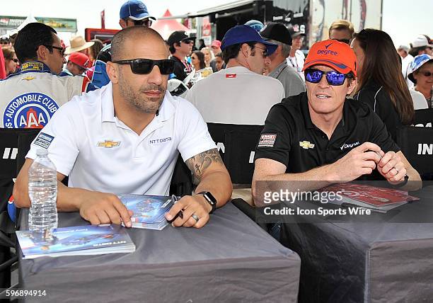 Chip Ganassi Racing Teams drivers Tony Kanaan and Scott Dixon wait to sign autographs for fans during a IndyCar autograph session before the MAVTV...
