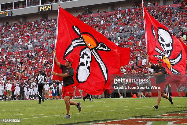 The flag runner runs with the Buccaneers logo flag mistakingly upside down during a touchdown celebration in the 2nd quarter of the NFL Week 1 game...