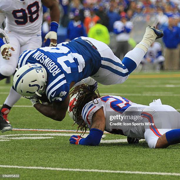 Indianapolis Colts running back Josh Robinson is tripped up by Buffalo Bills cornerback Stephon Gilmore during a NFL game between the Indianapolis...