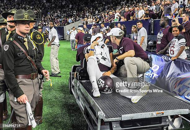 Texas A&M Aggies punter Drew Kaser is carted off the field after a roughing the kicker call during second half action of the Arizona St. Sun Devils...