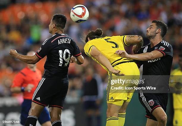 Columbus Crew defender Emanuel Pogatetz heads away between D.C. United forward Jairo Arrieta and D.C. United defender Steve Birnbaum during a MLS...