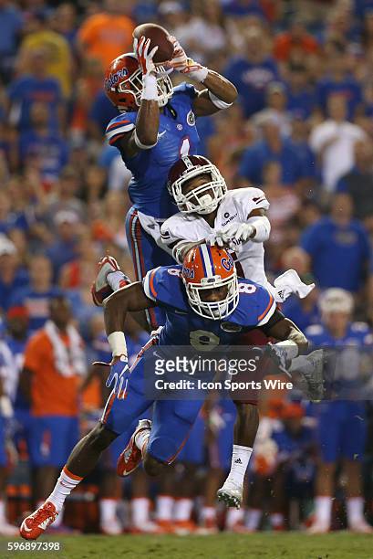 Florida Gators defensive back Vernon Hargreaves III intercepts a pass over New Mexico State wide receiver Tyrain Taylor and Florida Gators defensive...
