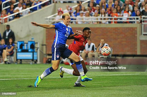Women's National team forward Abby Wambach can't get to this pass with Haiti defender Roselord Borgella defending during the game on Thursday...
