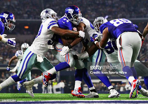 New York Giants running back Andre Williams is tackled by Dallas Cowboys outside linebacker Anthony Hitchens and strong safety Barry Church during a...