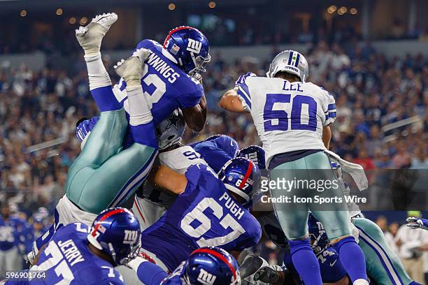 New York Giants Running Back Rashad Jennings [10336] leaps between Dallas Cowboys Linebacker Anthony Hitchens [12329] and Linebacker Sean Lee [10312]...
