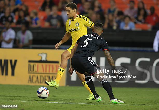 Columbus Crew defender Chris Klute controls the ball defended by D.C. United defender Sean Franklin during a MLS match at RFK Stadium, in Washington...