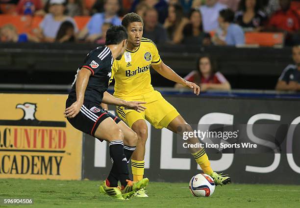 Columbus Crew defender Chris Klute controls the ball in front of D.C. United forward Fabian Espindola during a MLS match at RFK Stadium, in...