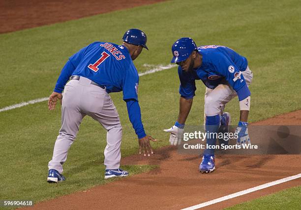 Chicago Cubs center fielder Dexter Fowler is greeted by third base coach Gary Jones after hitting home run during the fifth inning in the National...