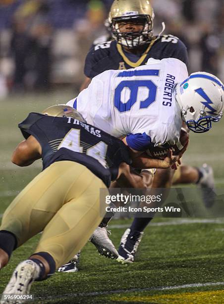 Air Force Falcons quarterback Karson Roberts scores but gets tackled by Navy Midshipmen linebacker Micah Thomas during the game between Air Force vs...