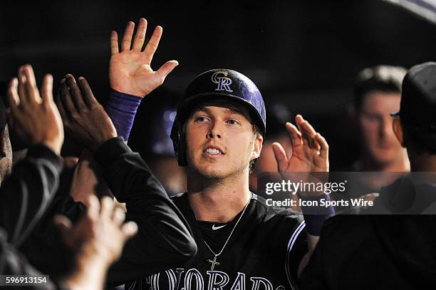 Colorado Rockies left fielder Corey Dickerson celebrates a run scored during a regular season Major League Baseball game between the San Diego Padres...