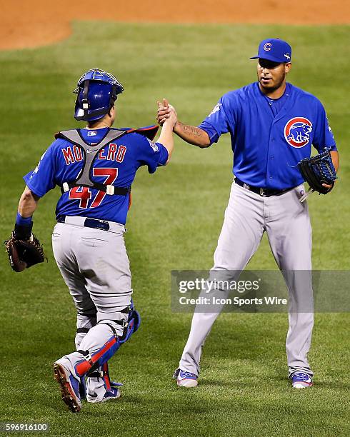 Chicago Cubs catcher Miguel Montero and relief pitcher Hector Rondon congratulate eacher after the Cubs defeated the St. Louis Cardinals 6-3 in game...