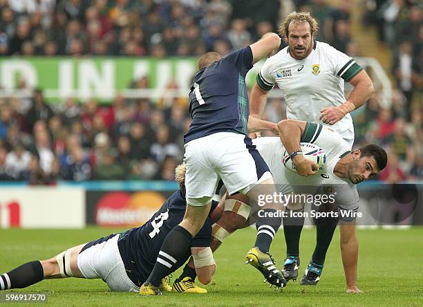 South Africa's Damian de Allende is tackled by Scotland's Richie Gray and Gordon Reid during the Pool B play between South Africa and Scotland at St...