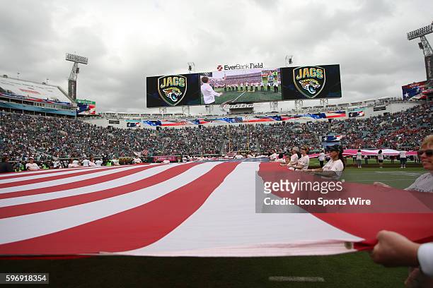 Breast cancer survivors help hold an american flag during the pre game between the Jacksonville Jaguars and the Houston Texans at the Everbank Field...