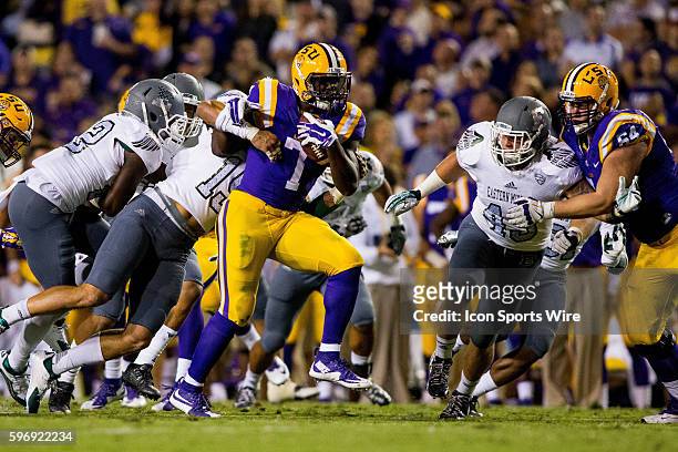 Tigers running back Leonard Fournette is tackled by a host of tacklers lead by Eastern Michigan Eagles wide receiver Aloyis Gray during the game...