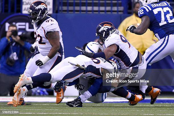 Indianapolis Colts Quarterback Andrew Luck [14978] is hit and tackled by Denver Broncos Linebacker Danny Trevathan [17696] and Denver Broncos...