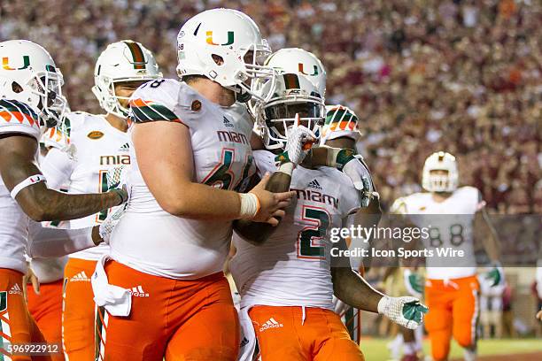 Miami RB Joseph Yearby quiets the Florida State student section after scoring a touchdown during the game between the Florida State Seminoles and the...