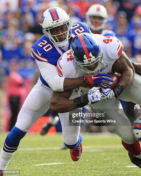 New York Giants running back Andre Williams is tackled by Buffalo Bills free safety Corey Graham during a NFL game between the New York Giants and...