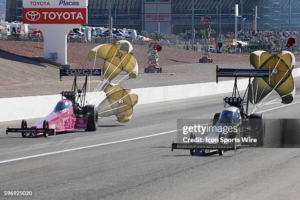 Antron Brown DSR NHRA Top Fuel Dragster and Tony Schumacher DSR Army NHRA Top Fuel Dragster pull their parachutes during the 15th Annual NHRA Toyota...