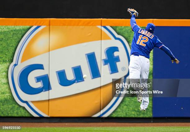 New York Mets center fielder Juan Lagares [7887] can't flag down a fly-ball double by Chicago Cubs shortstop Starlin Castro during the fifth inning...