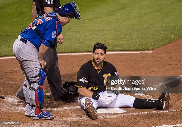 Pittsburgh Pirates catcher Francisco Cervelli sits on the ground after being hit by a pitch during the fifth inning in the National League Wild Card...