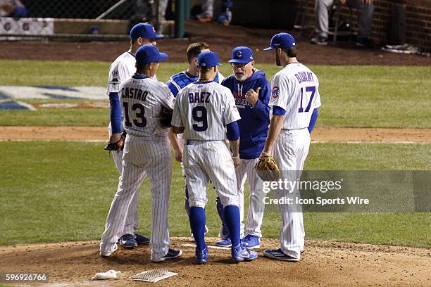 Chicago Cubs Manager Joe Maddon talks to Chicago Cubs third baseman Kris Bryant , Chicago Cubs second baseman Javier Baez , Chicago Cubs shortstop...