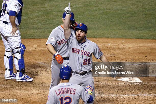 New York Mets second baseman Daniel Murphy celebrates with third baseman David Wright and center fielder Juan Lagares his two run home run in the...