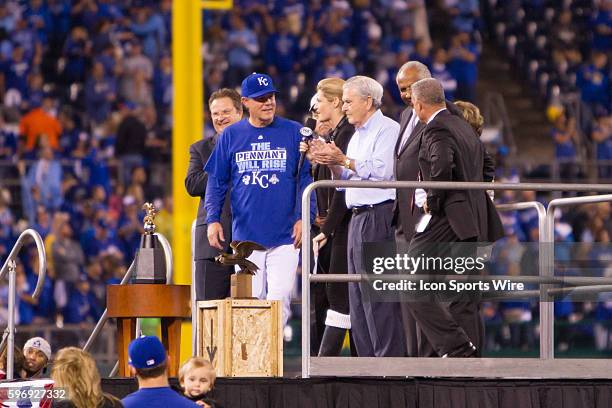 Kansas City Royals manager Ned Yost accepts the American League trophy after winning the MLB American League Championship Series game 6 between the...