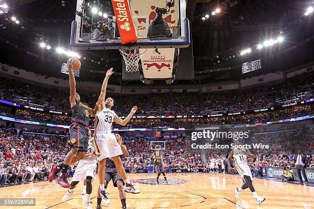 Atlanta Hawks guard Jeff Teague dunks the ball on New Orleans Pelicans forward Ryan Anderson during the game between Atlanta Hawks and New Orleans...