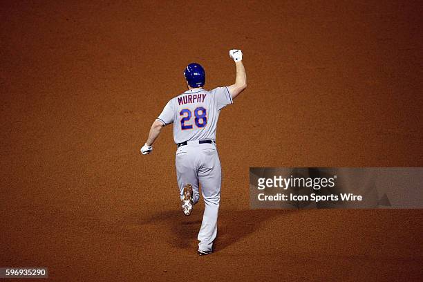 New York Mets second baseman Daniel Murphy celebrates his two run home run in the eighth inning in game four action of the National League...