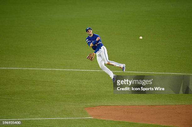 Oct 20, 2015; Toronto, Ontario, CAN; Toronto Blue Jays shortstop Troy Tulowitzki throws to first base in the ninth inning against Kansas City Royals...
