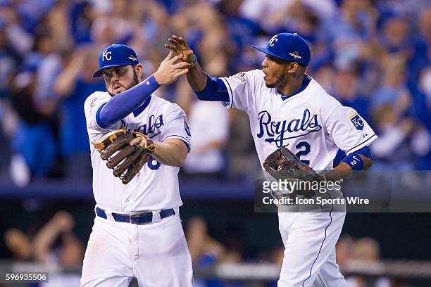 Kansas City Royals third baseman Mike Moustakas high fives Kansas City Royals shortstop Alcides Escobar during the MLB American League Championship...