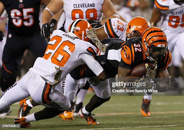 Cincinnati Bengals halfback Jeremy Hill dives for the first down under pressure from Cleveland Browns' Pierre Desir and Craig Robertson during the...