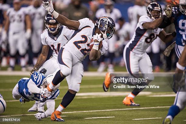 Indianapolis Colts safety Colt Anderson trips up Denver Broncos running back C.J. Anderson during a NFL game between the Indianapolis Colts and...